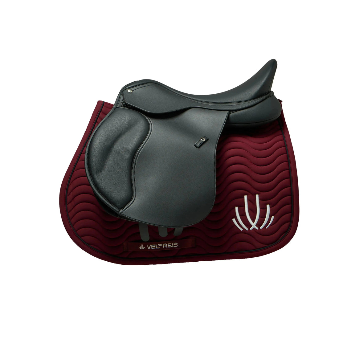 Six horse saddle pads in different colors and textures arranged in two rows on small wooden stands against a warm brown background. The top row features curved saddle pads in burgundy, navy blue, and cream, while the bottom row features rectangular saddle pads in gray and black.