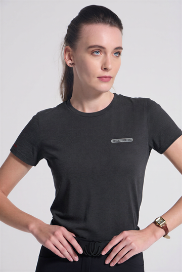 Woman wearing a Charcoal grey t-shirt with a logo on a light gray background