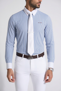 Man wearing a light blue striped dress shirt with a white collar and cuffs, paired with white pants on a plain background.