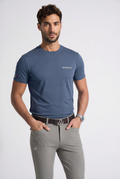 Man wearing a blue t-shirt and TAN pants on a white background