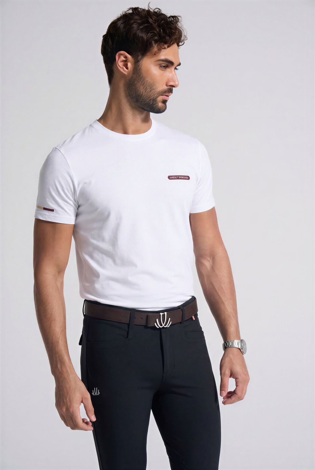 Man wearing a VEL DE REIS green t-shirt and green riding pants on a white background