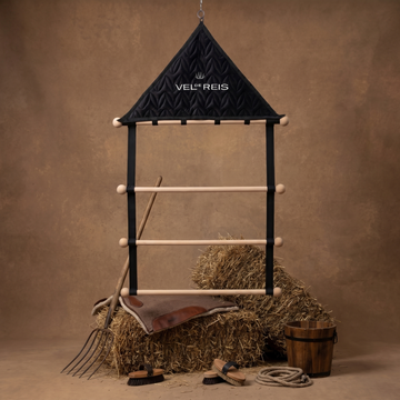 Horse stable with hay, tools, and a saddle  pad hanger from VEL DE REIS on a brown background