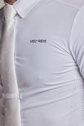 Close-up of a white collared shirt with a white tie, featuring the black printed brand name 'VEL REIS' on the chest.