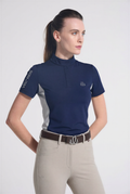 Woman wearing a navy equestrian Training shirt with a logo on a white background